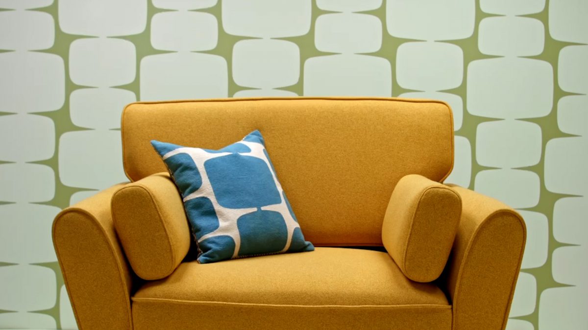 Habitat - a yellow sofa with a blue patterned cushion