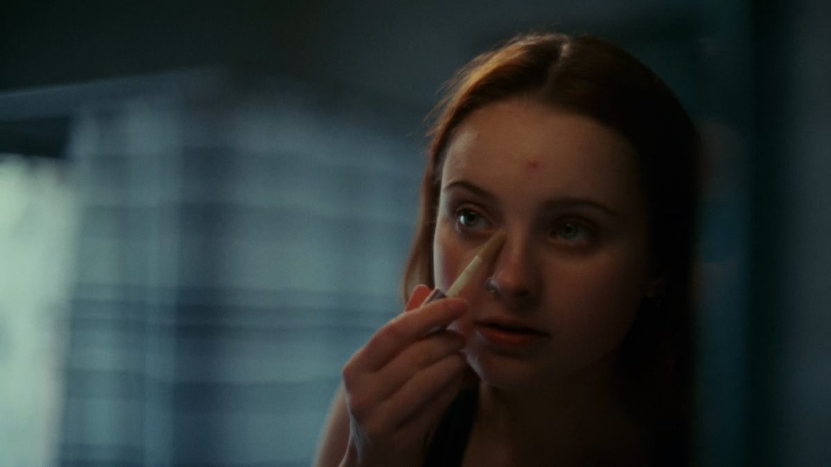 Housing Matters - A young lady applying makeup in the mirror