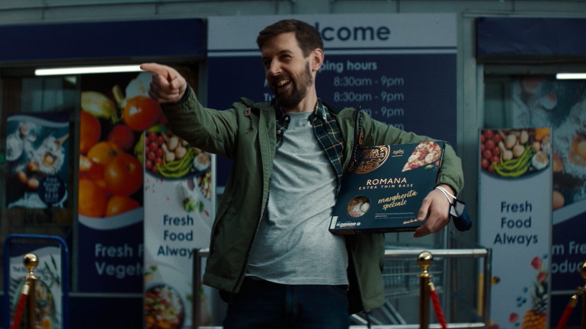 Pizza Express - main holding a takeaway pizza laughing